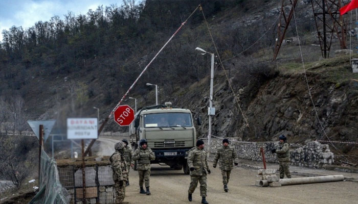 Azerbaijani soldiers patrol at a checkpoint outside the town of Susa. —rferl.org