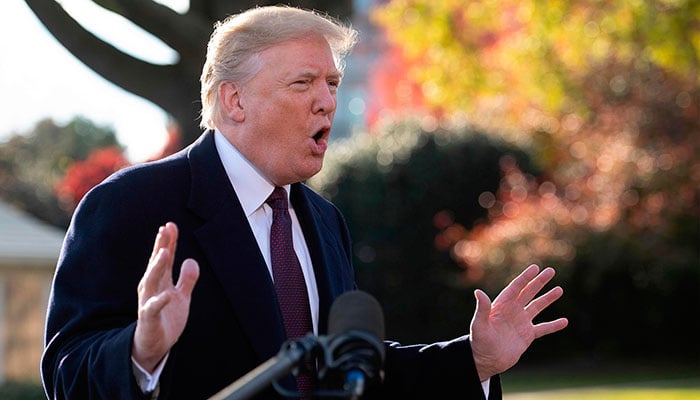 US President Donald Trump speaks to the press as he departs the White House in Washington, DC, on November 20, 2018 / AFP