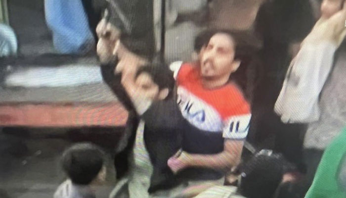 The suspected attacker of Imran Khan before he was arrested. Screengrab of a Twitter video.
