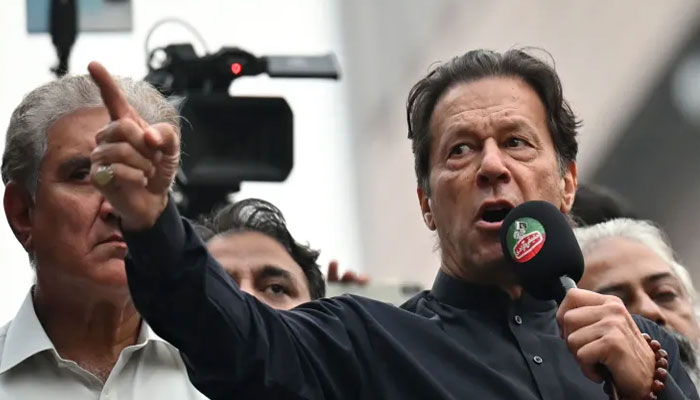 Pakistan’s former prime minister Imran Khan (R) addresses his supporters during an anti-government march towards capital Islamabad, demanding early elections, in Gujranwala on November 1, 2022. — AFP
