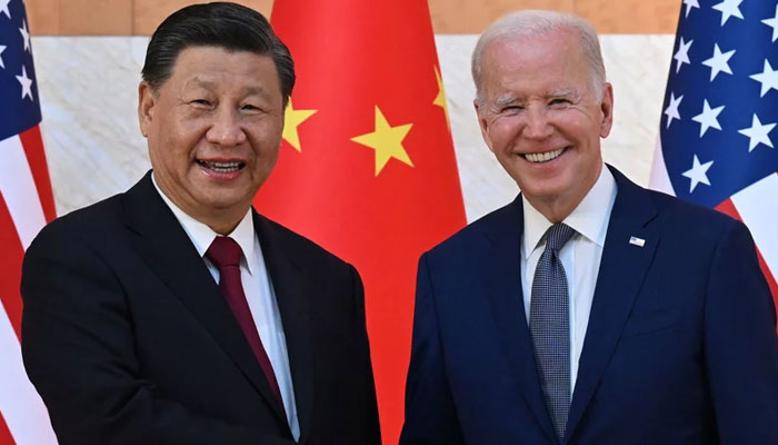 President Biden and Chinas President Xi Jinping shake hands as they begin talks in Bali. AFP