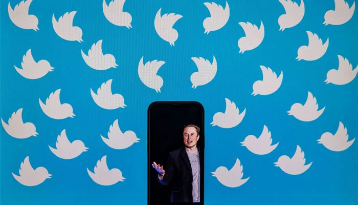 This file photo illustration taken on August 05, 2022, shows a cellphone displaying a photo of Elon Musk placed on a computer monitor filled with Twitter logos in Washington, DC. — AFP