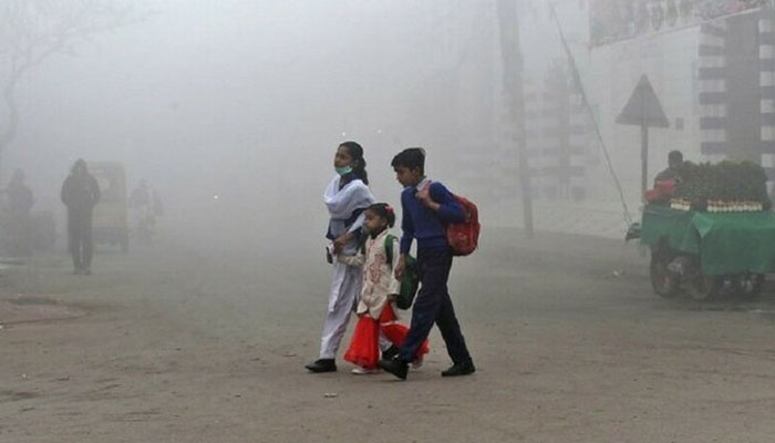 Students are seen heading to school amid smog in Lahore. Twitter
