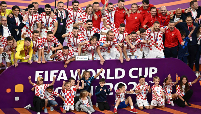 Croatias players celebrate with medals after winning the Qatar 2022 World Cup football third place play-off match between Croatia and Morocco at Khalifa International Stadium in Doha on December 17, 2022. AFP