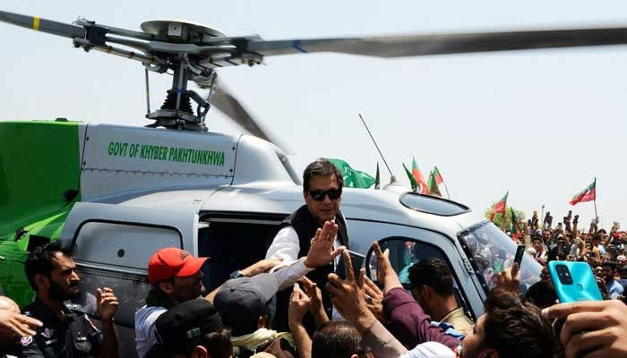 Representational image of PTI Chairman Imran Khan (C) arrives on a helicopter to lead a protest rally in Swabai on May 25, 2022. — AFP