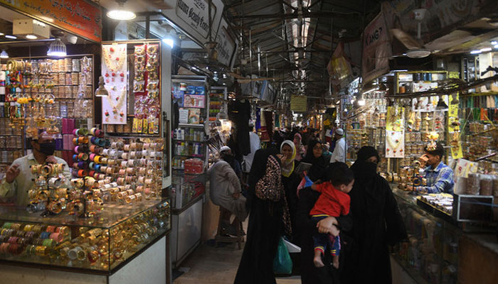 People shop in a market in Karachi on May 11, 2020. (AFP/FILE)