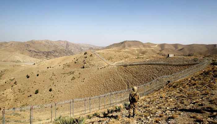 A soldier stands guard along the border fence outside the Kitton outpost on the border with Afghanistan in North Waziristan, Pakistan October 18, 2017. —Reuters/File