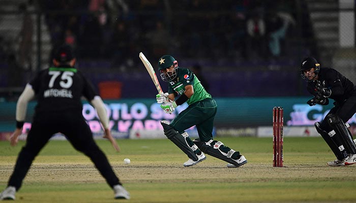 Pakistan´s captain Babar Azam (C) plays a shot during the second one-day international (ODI) cricket match between Pakistan and New Zealand at the National Stadium in Karachi on January 11, 2023. — AFP