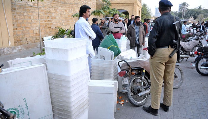 Polling staff take polling material from the YMCA ground for the local bodies elections in Karachi on January 14, 2023. APP