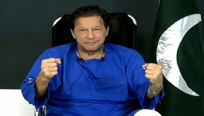 Imran Khan addressing his party workers from hospital after attempted assassination. Screengrab of a Twitter video.