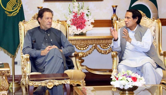 Imran Khan listens to former Punjab Chief Minister Chaudhry Parvez Elahi. — PPI/File