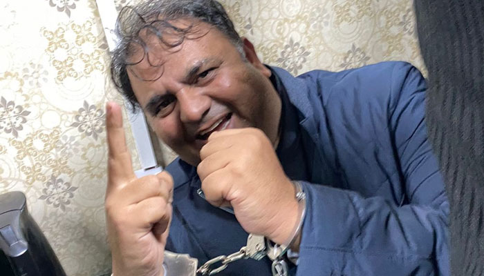 PTI leader Fawad Chaudhry in cuffs. Twitter