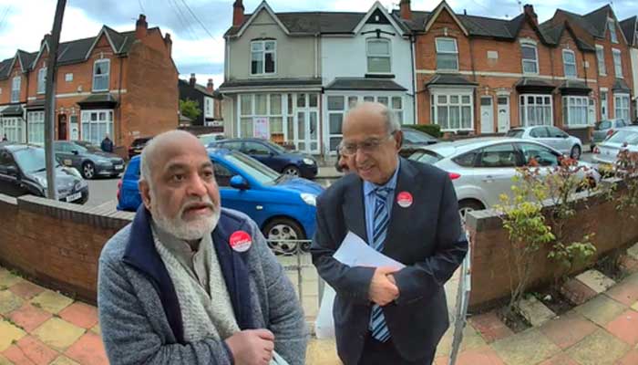 Screengrab of the video evidence that Muhammad Afzal campaigning at the doorsteps with a fellow offering Khajoors to Muslim voters in return for votes for the Labour Party. — provided by author