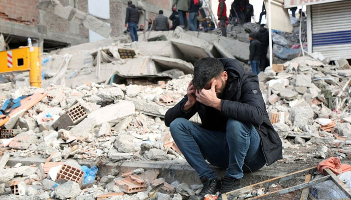 A man reacts as people search for survivors through the rubble in Diyarbakir. — AFP