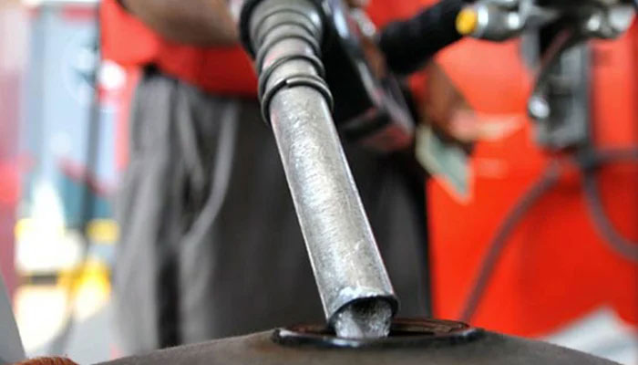 A worker at a fuel station fills the petrol tank of a motorcycle. — AFP/File