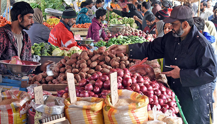 People are busy in buying vegetables in Sunday weekly bazaar at Shadman area in Lahore. — Online/File