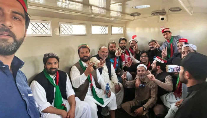 PTI workers gesture in a police van during the partys Jail Bharo Tehreek in Peshawar, on February 23, 2023. — Geo.tv/Abu Bakr Siddiqui