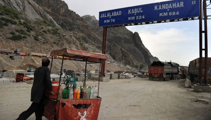 An Afghan trader pushes a drinks cart along the Torkham border. AFP