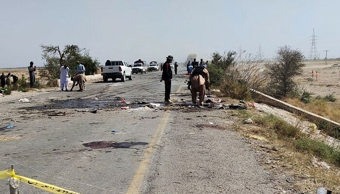 Security officials examine the site after a suicide attack on a police truck near Dhadar, the main town of Kachhi district, about 120 km southeast of Quetta in Balochistan province on March 6, 2023. — AFP