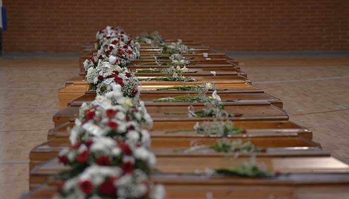 A photograph taken on February 28, 2023 shows the coffins of the migrants who died two days day before, after their boat sank off Italy´s southern Calabria region, at the Crotone Palasport. — AFP