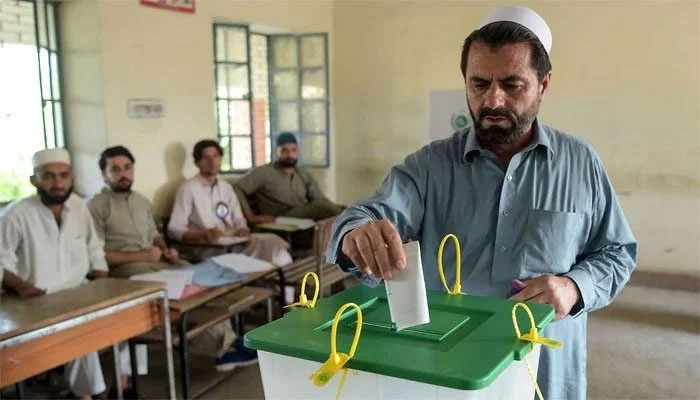The picture shows a man casting vote in the ballot. — AFP/File