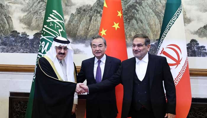 Saudi Arabias Musaad bin Mohammed Al Aiban (left), China’s top diplomat Wang Yi and Irans Ali Shamkhani stand together in Beijing on Friday. — China Daily