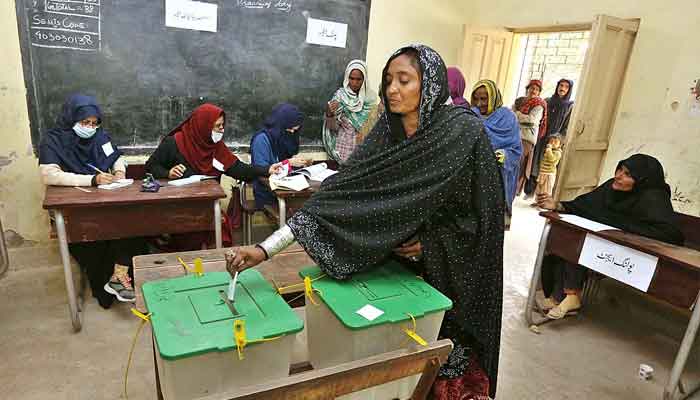 A woman casts her vote at a polling station during local government elections in Hyderabad on January 15. —APP