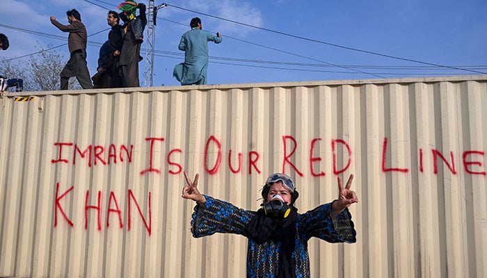 Former Prime Minister Imran Khans supporters stand atop a shipping container placed for Khans security outside a court in Islamabad on March 18, 2023. AFP