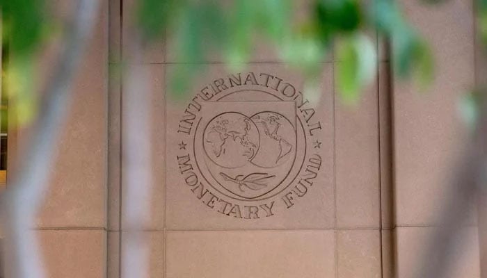 The International Monetary Fund (IMF) logo is displayed outside its headquarters in Washington, DC, on October 8, 2022. — AFP