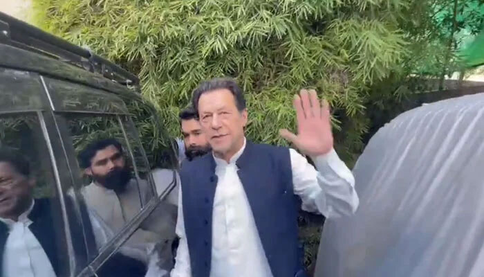Pakistan Tehreek-e-Insaf (PTI) Chairman Imran Khan waves before siting in his car at his Zaman Park residence in Lahore. — Screengrab/Twitter/@MusarratCheema