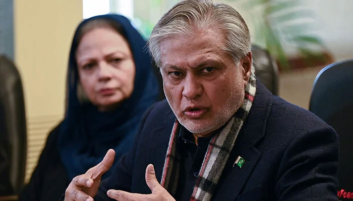 Finance Minister Ishaq Dar (right) speaks during a press conference in Islamabad on February 10, 2023. — AFP