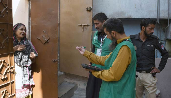 A Pakistan Bureau of Statistics official uses a digital device to collect information from a resident during door-to-door data collection at the first-ever digital national census on March 28, 2023. — ONLINE