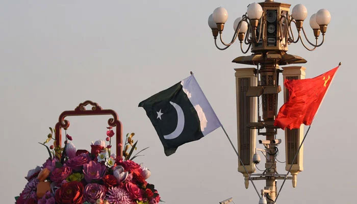 Pakistani and Chinese national flags flutter next to an installation featuring a giant flower basket at Tiananmen Square in Beijing, China October 7, 2019. —File