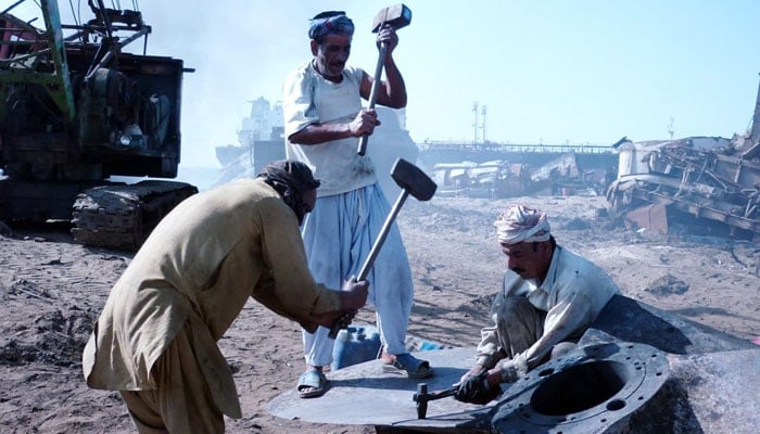 Labours working in a vehicle scrapward.—The News/file
