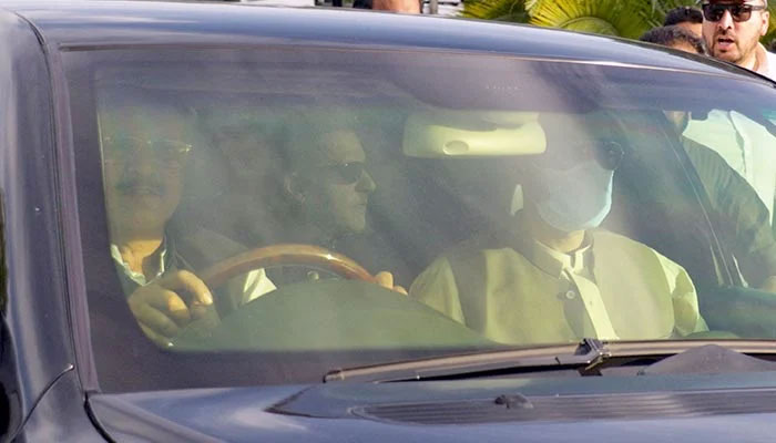 A car carries former prime minister Imran Khan, as he arrives to appear before the Supreme Court in Islamabad on May 11, 2023. — AFP