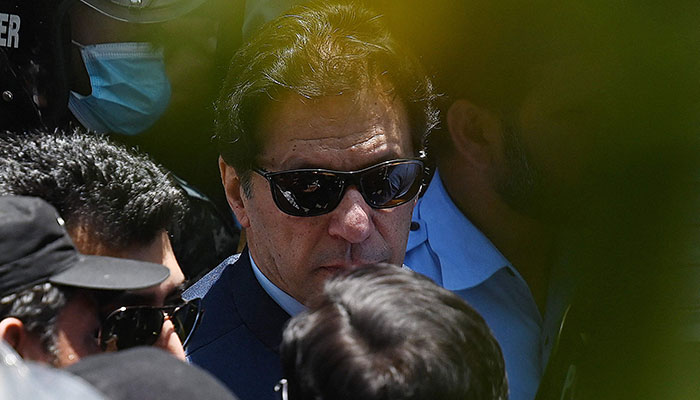 Police commandos escort former Pakistan´s Prime Minister Imran Khan as he arrives at the high court in Islamabad on May 12, 2023. Former Pakistan prime minister Imran Khan was granted bail by the Islamabad High Court on May 12, after his arrest on corruption charges this week sparked deadly clashes before being declared illegal.—AFP