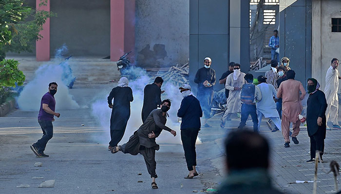 Pakistan Tehreek-e-Insaf (PTI) party activists and supporters of former Pakistan´s Prime Minister Imran Khan clash with police during a protest against the arrest of their leader, in Karachi on May 10, 2023. —AFP