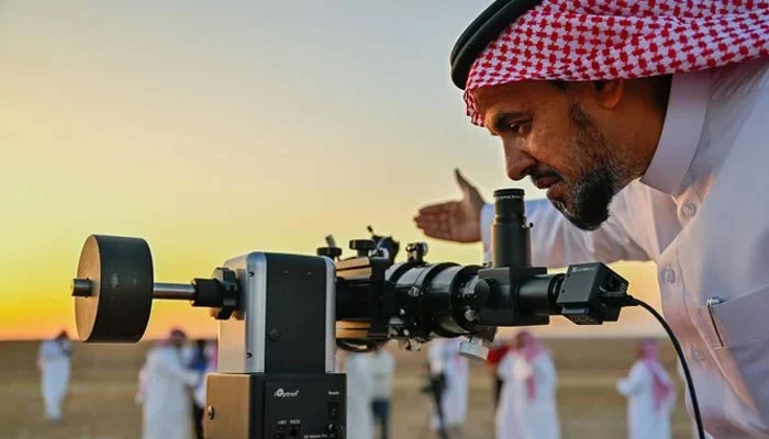 A man looks through a telescope to sight crescent. — Saudi Press Agency/File