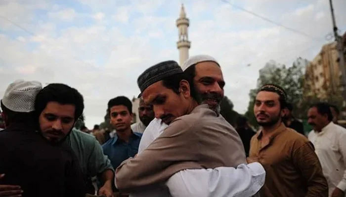 Men embracing each other after Eid prayers. — AFP/File