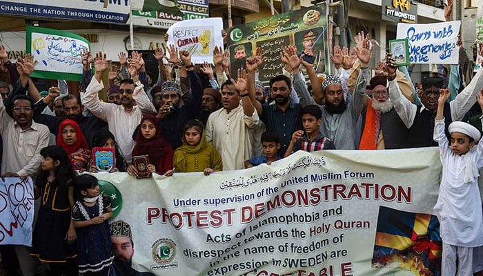 People take part in a demonstration in Karachi on July 2 as they protest against the burning of the Holy Quran outside a Stockholm Mosque. — AFP/File