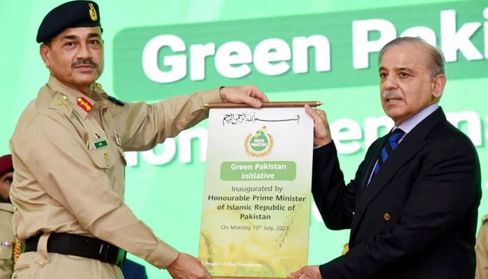Chief of Army Staff General Asim Munir hands over the inaugural scroll to Prime Minister Shehbaz Sharif during the inaugural ceremony of the Green Pakistan Initiative in Islamabad on July 10, 2023. — PID
