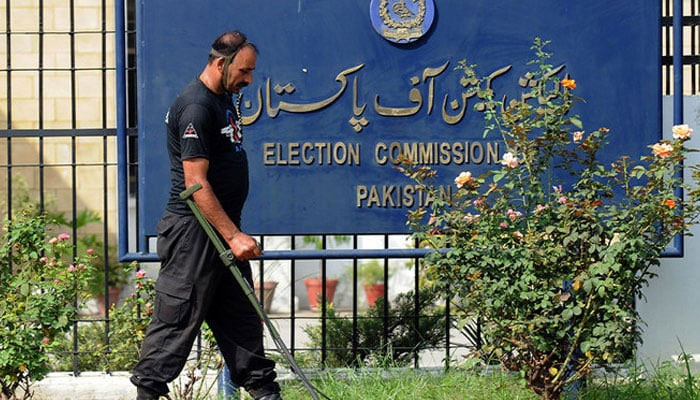 A personnel of the anti-terrorist force uses a metal detector to check the area of the election commission in Islamabad on August 26, 2008. — AFP