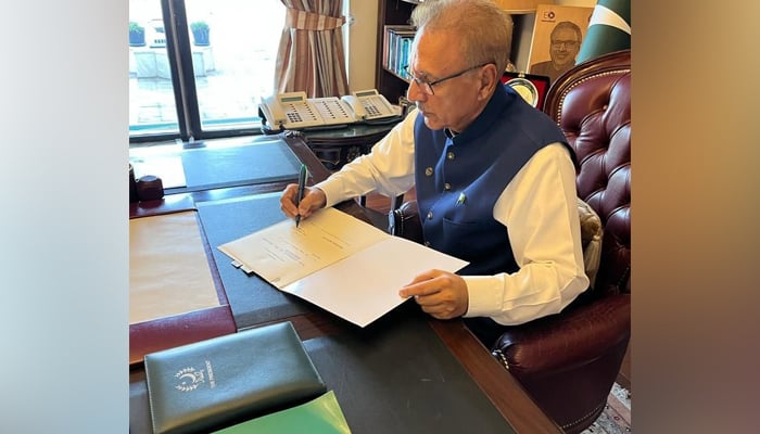 President Arif Alvi while signing a document in the President House Islamabad. — Twitter/@PresOfPakistan