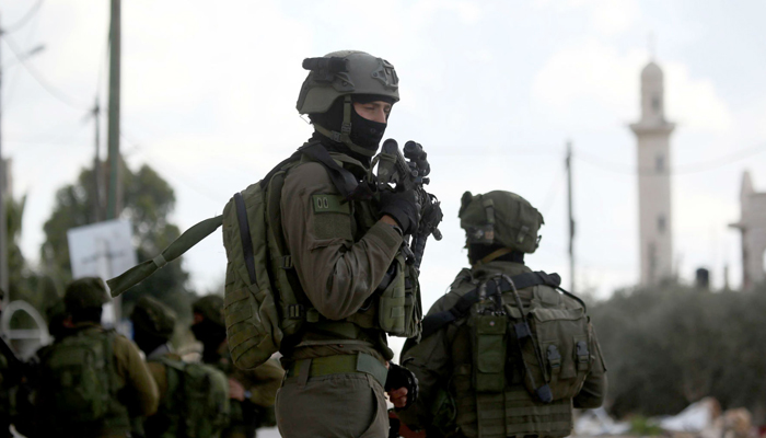 Personnel from the Israeli forces can be seen standing alert in this picture. — AFP/File