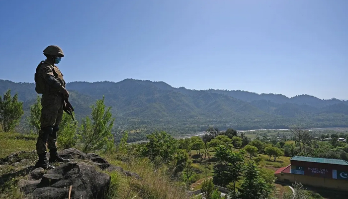 A Pakistani soldier stands guard near the Line of Control, the de facto border between India and Pakistan at Salohi village in the Poonch district of Kashmir on April 26, 2021. — AFP
