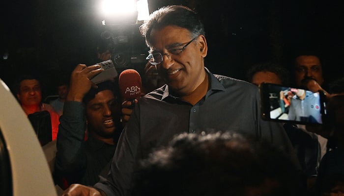 Former finance minister Asad Umar leaves after announcing to step down from his party position when he was released from prison in Islamabad on May 24, 2023. — AFP