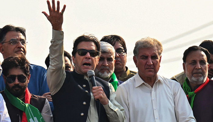 Former prime minister Imran Khan (C) addresses his supporters flanked by Shah Mahmood Qureshi (right) and others in the back in Lahore. — AFP/File