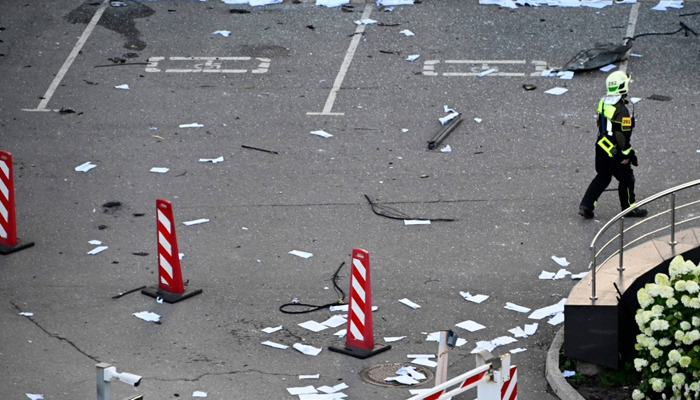 A firefighter walks among papers and broken glass Sunday outside a damaged office block of the Moscow International Business Center following a reported drone attack. — AFP/File