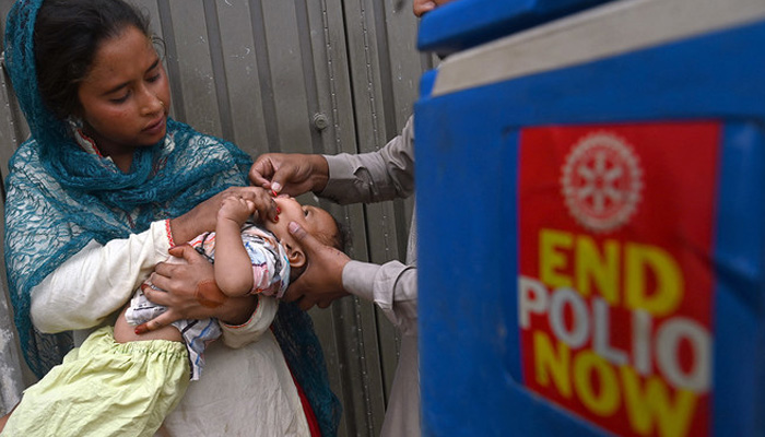A polio team administers vaccine. — AFP