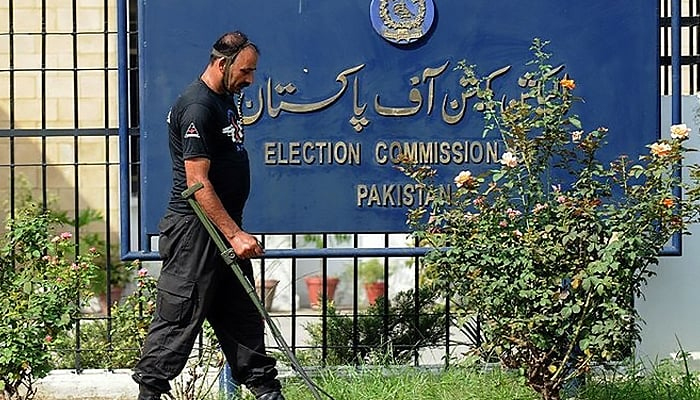 Anti-terrorist force member uses a metal detector to check the area of the Election Commission of Pakistan in Islamabad. — AFP/File